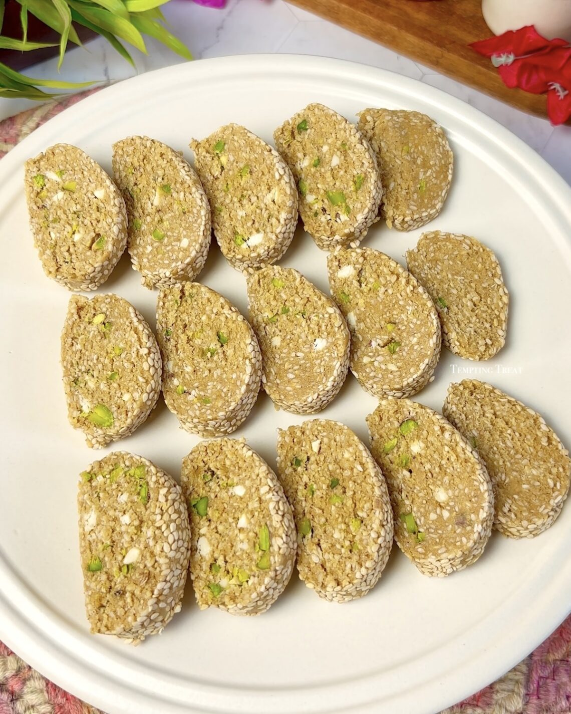 Sliced Til Mawa Roll on a festive plate for Makar Sankranti