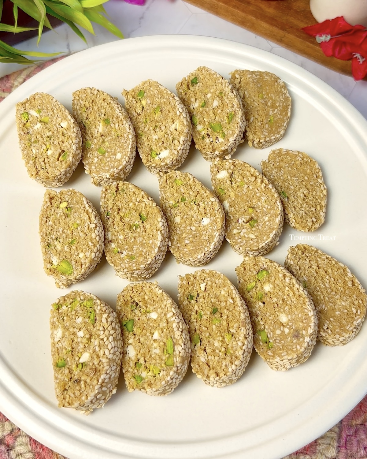 Sliced Til Mawa Roll on a festive plate for Makar Sankranti